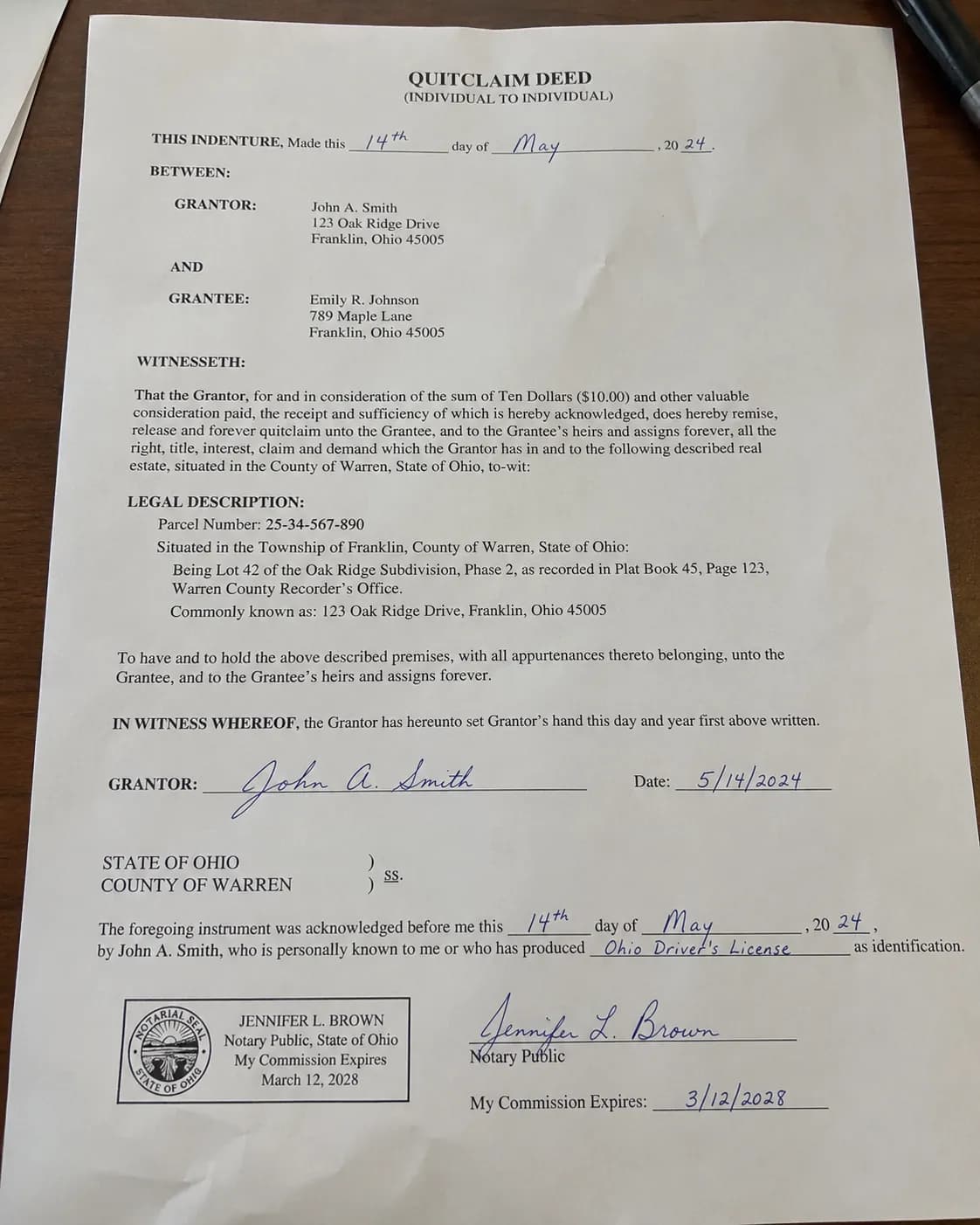A signed quitclaim deed with a notary seal
