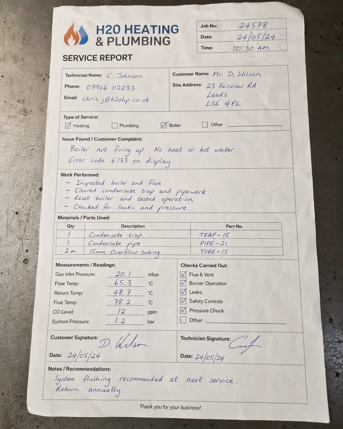 A handwritten plumbing service and repair report